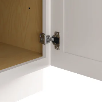 Concealed 6-way adjustable soft-close hinge inside a plywood cabinet